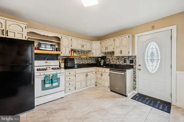 a kitchen with stainless steel appliances a refrigerator sink and cabinets