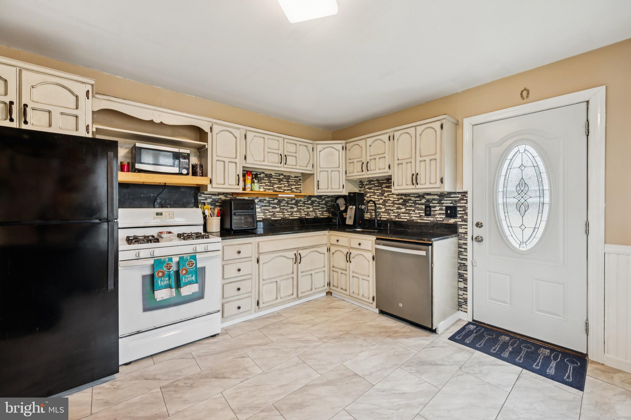 2409 Fries Mill Road Williamstown, NJ 08094 - Photo 9 of 30 a kitchen with stainless steel appliances a refrigerator sink and cabinets
