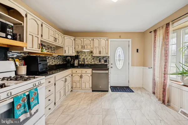 a kitchen with stainless steel appliances granite countertop a stove and a refrigerator