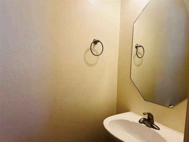a bathroom with a sink and mirror