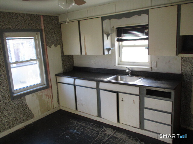 71 Broad Street Meriden, CT 06450 - Photo 11 of 21 a kitchen with a sink cabinets and a window