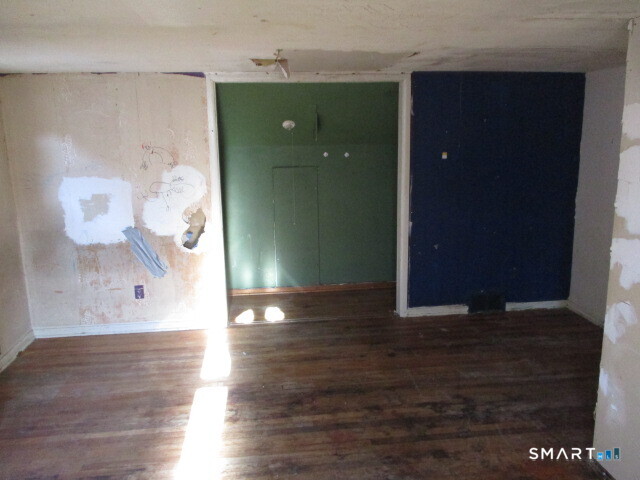 71 Broad Street Meriden, CT 06450 - Photo 15 of 21 an empty room with wooden floor and windows