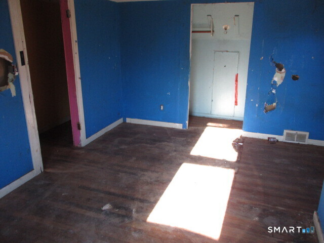 71 Broad Street Meriden, CT 06450 - Photo 17 of 21 an empty room with a mirror