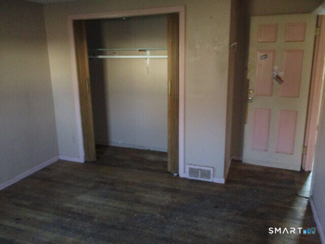 71 Broad Street Meriden, CT 06450 - Photo 8 of 21 an empty room with wooden floor sink and closet