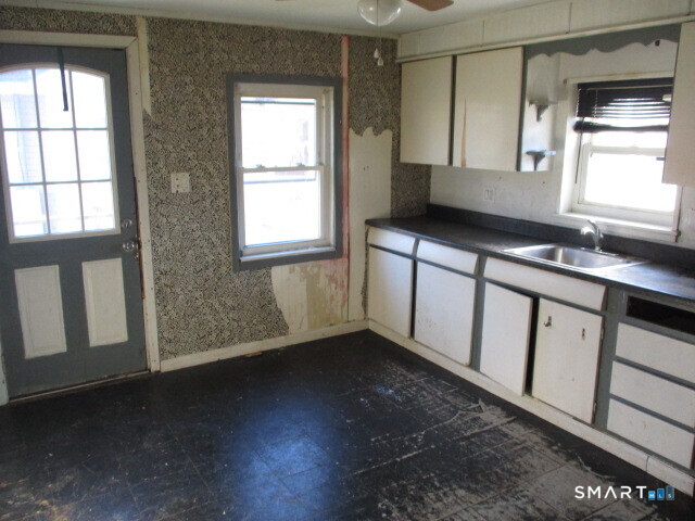 71 Broad Street Meriden, CT 06450 - Photo 10 of 21 a kitchen with a sink and cabinets