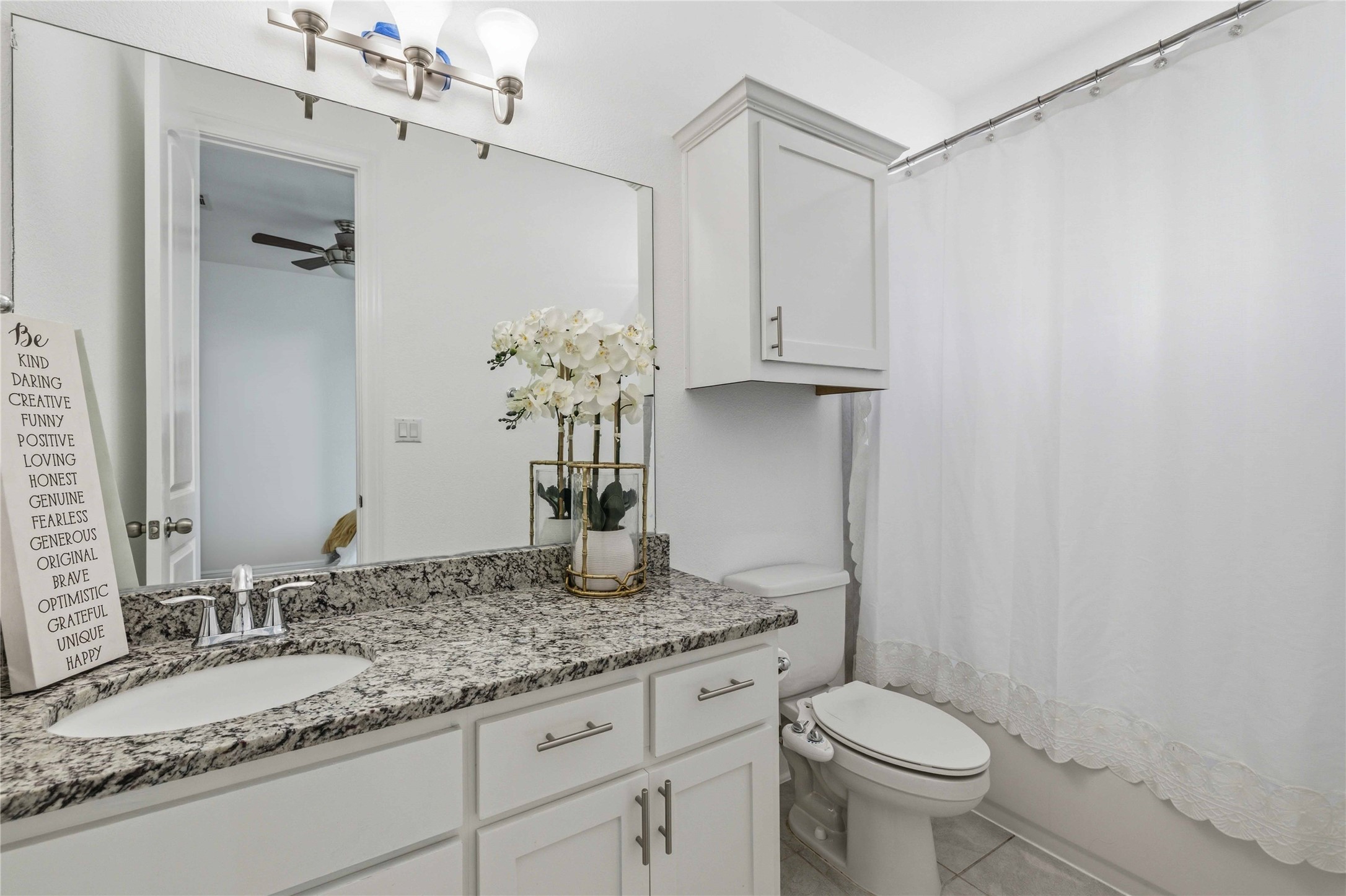 1517 Bardella Drive Leander, TX 78641 - Photo 17 of 40 Bathroom featuring vanity, shower / bath combo, light tile patterned floors, and ceiling fan
