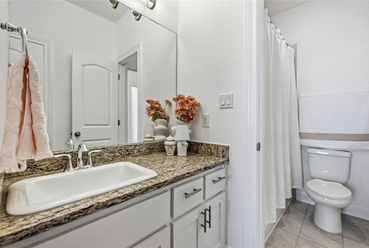 1517 Bardella Drive Leander, TX 78641 - Photo 24 of 40 Bathroom with a shower with curtain, vanity, and light tile patterned floors