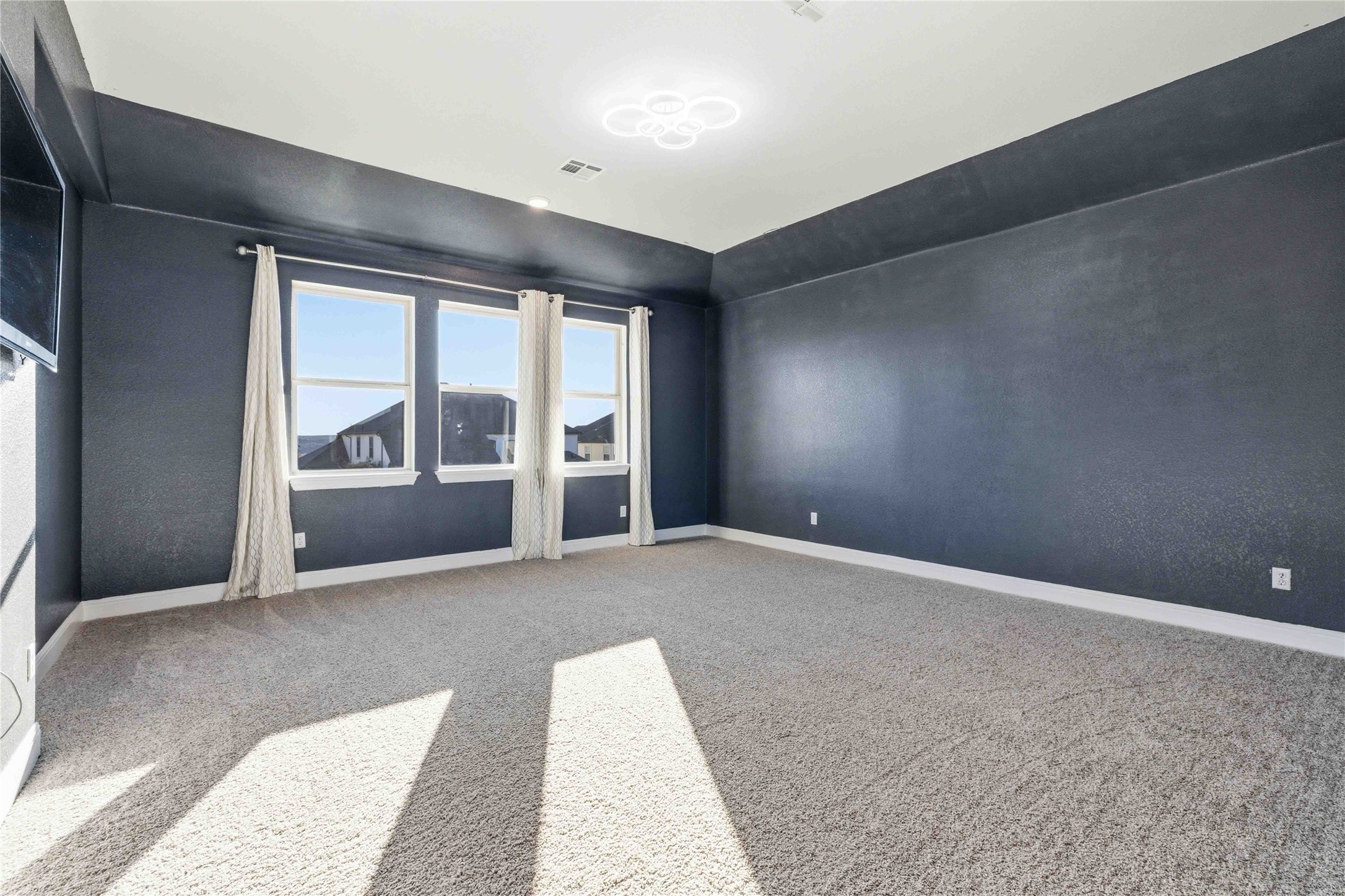 1517 Bardella Drive Leander, TX 78641 - Photo 28 of 40 Spacious game room with baseboards and light colored carpet