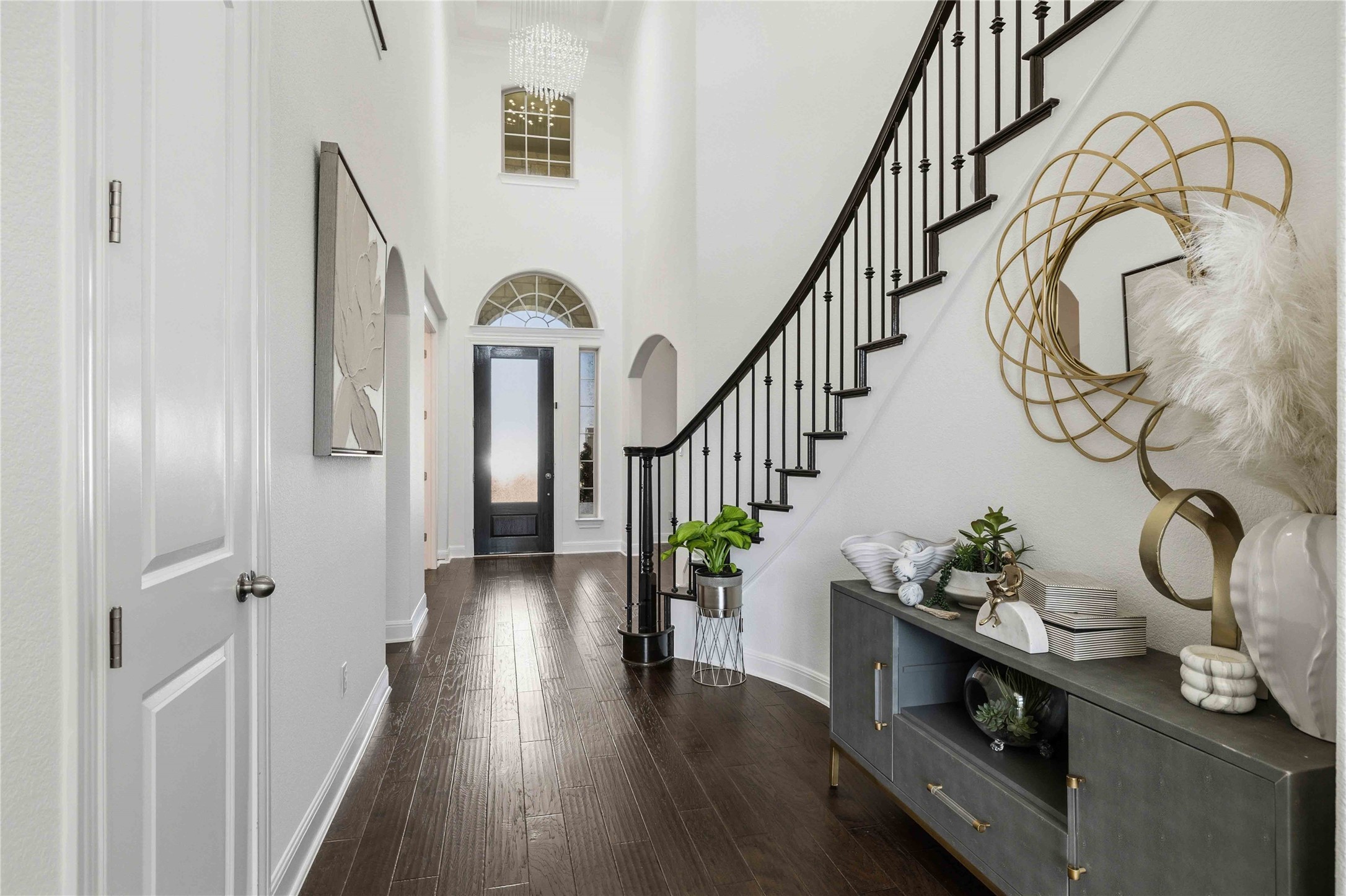 1517 Bardella Drive Leander, TX 78641 - Photo 3 of 40 Foyer entrance featuring a high ceiling, rich dark wood-style floors, and designer chandelier