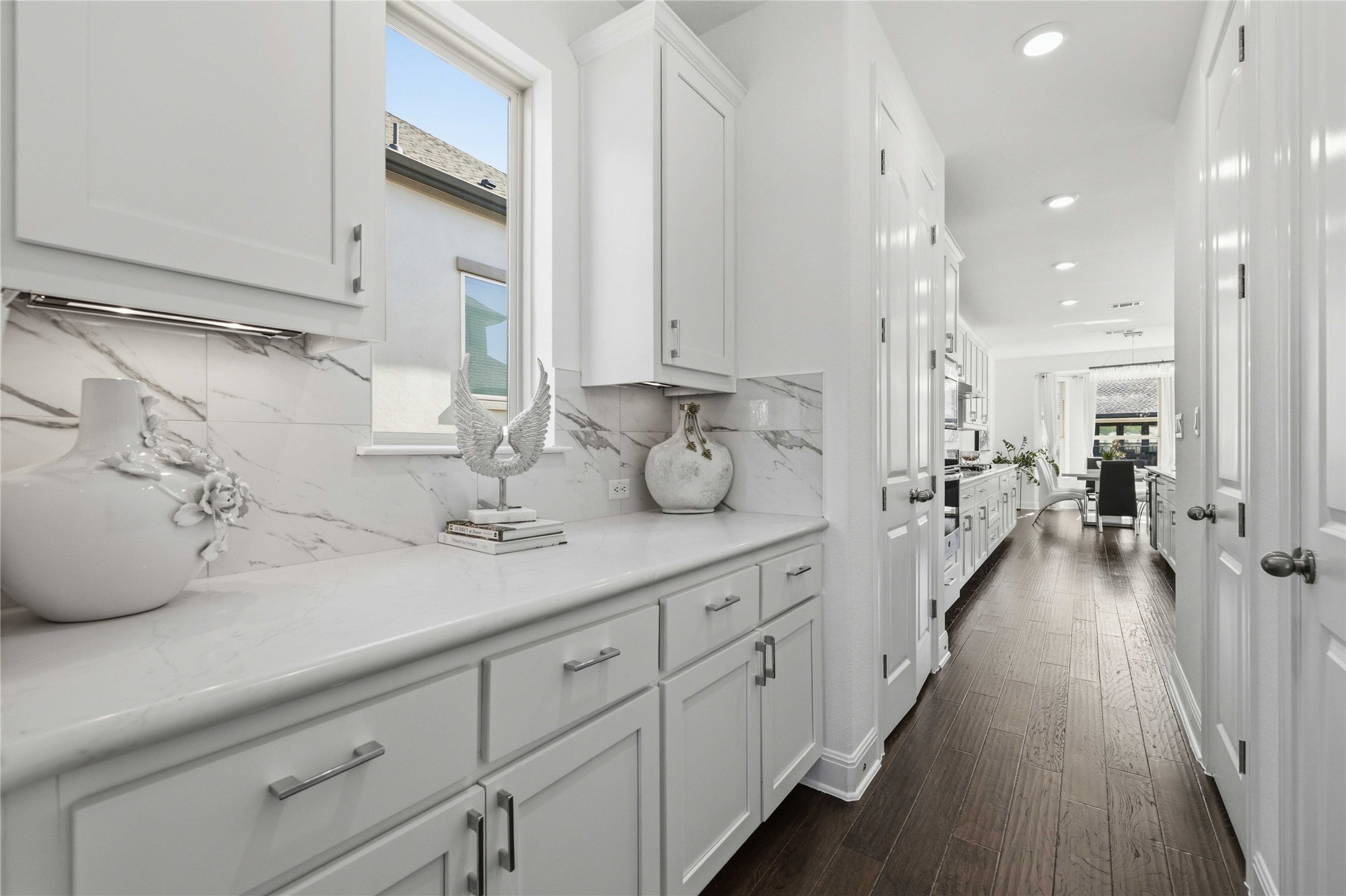1517 Bardella Drive Leander, TX 78641 - Photo 10 of 40 Butler's pantry with white cabinetry, quartz countertops and porcelain tile backsplash