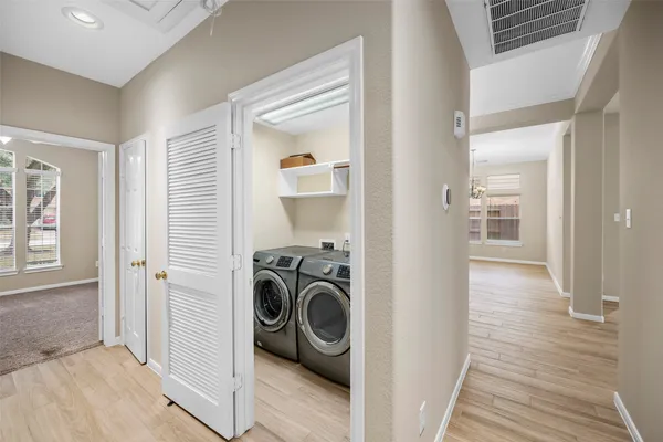 a view of a hallway with washer and dryer