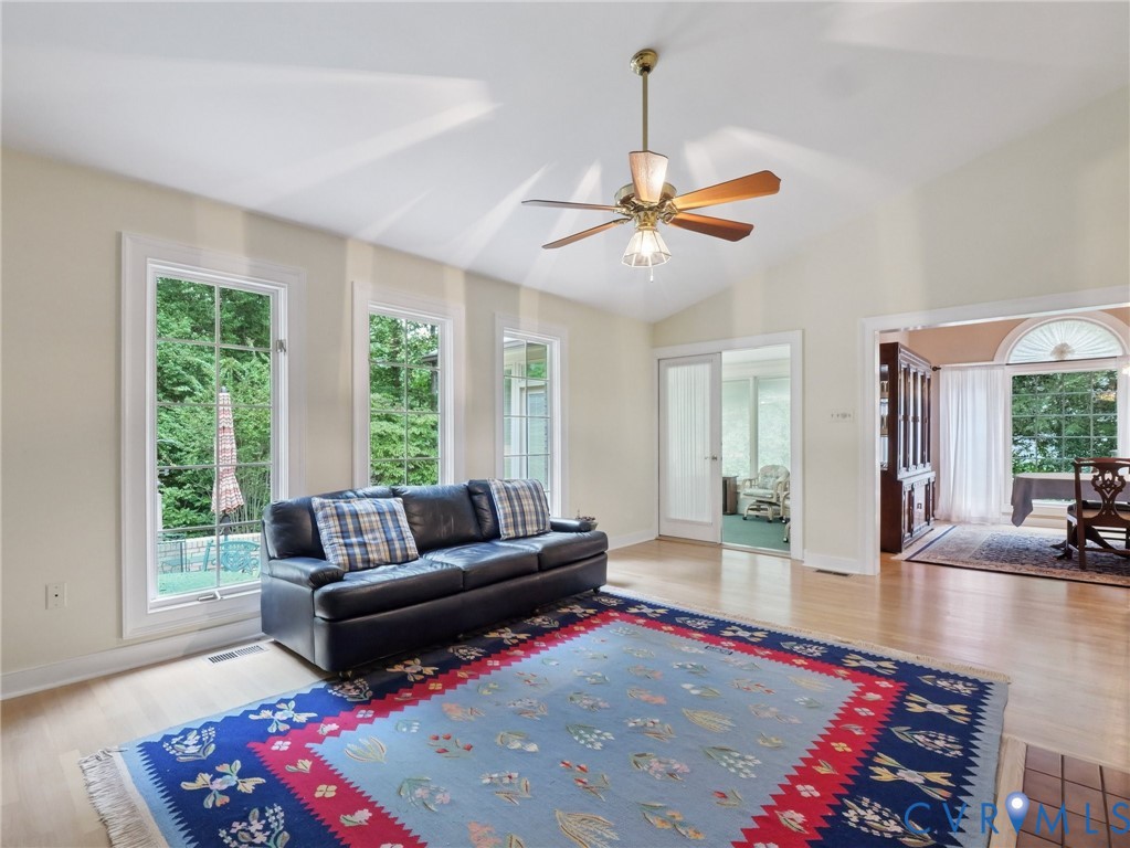 9010 Kings Crown Road North Chesterfield, VA 23236 - Photo 11 of 36 a living room with furniture and a chandelier