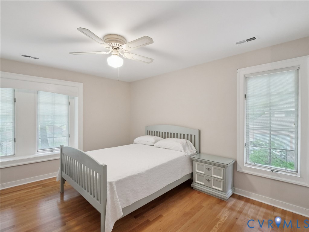 9010 Kings Crown Road North Chesterfield, VA 23236 - Photo 16 of 36 a bedroom with a bed and a large window with wooden floor