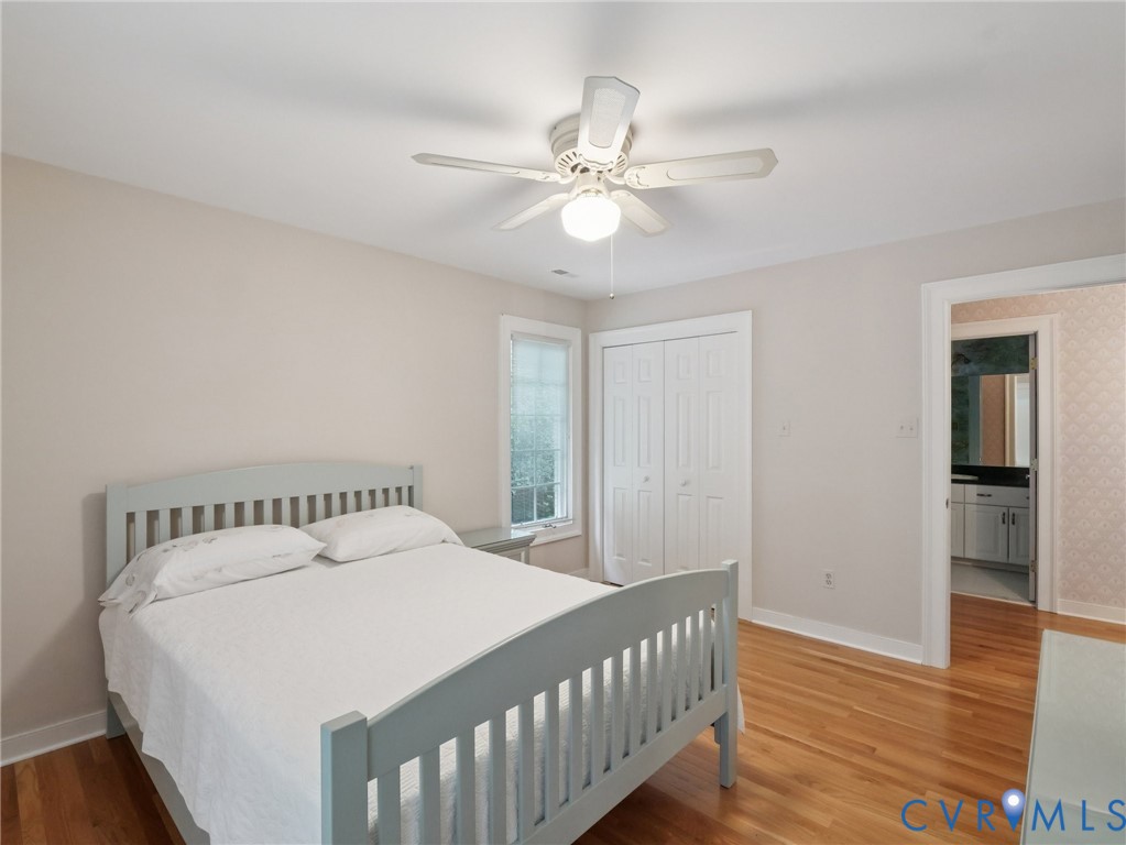 9010 Kings Crown Road North Chesterfield, VA 23236 - Photo 17 of 36 a bedroom with a bed and a chandelier