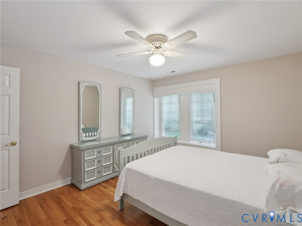 9010 Kings Crown Road North Chesterfield, VA 23236 - Photo 18 of 36 a bedroom with a bed and a chandelier