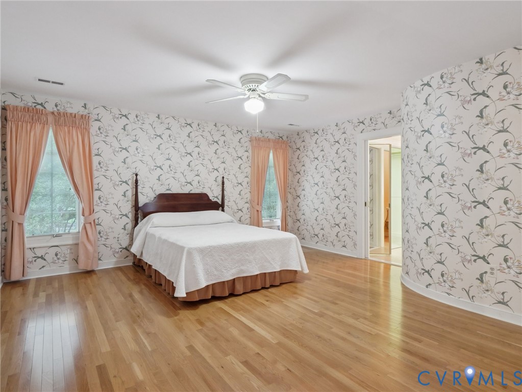 9010 Kings Crown Road North Chesterfield, VA 23236 - Photo 20 of 36 a bedroom with a bed and wooden floor
