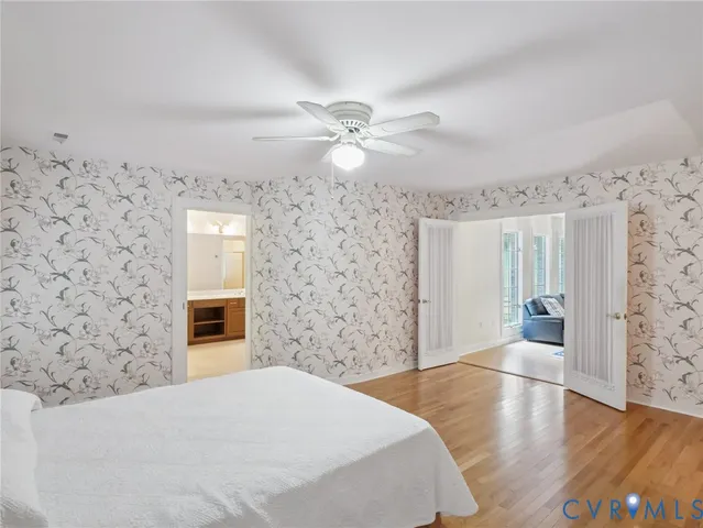 a spacious bedroom with a bed and a chandelier