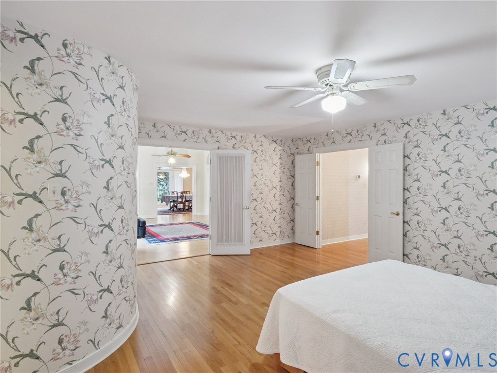 9010 Kings Crown Road North Chesterfield, VA 23236 - Photo 22 of 36 a bedroom with a bed and a chandelier