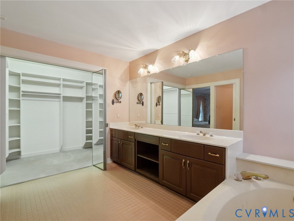 9010 Kings Crown Road North Chesterfield, VA 23236 - Photo 25 of 36 a spacious bathroom with a tub sink and mirror