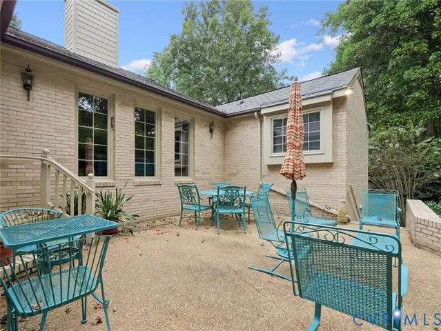 a view of house with a chairs and table in a patio