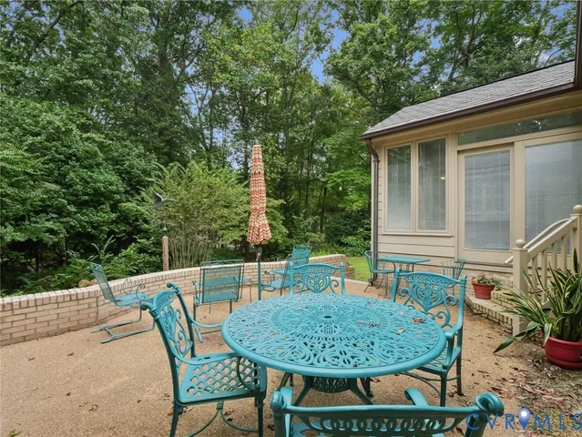 a view of a chair and table in the patio