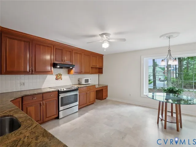 a kitchen with a stove a sink and a refrigerator