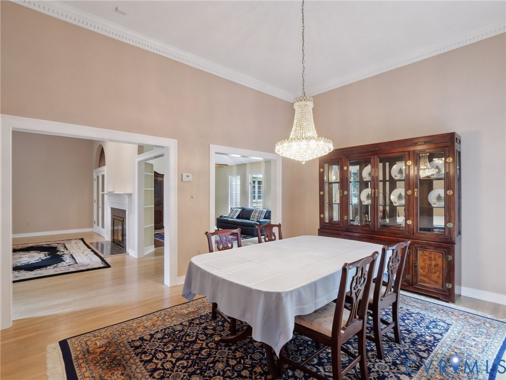 9010 Kings Crown Road North Chesterfield, VA 23236 - Photo 6 of 36 a view of a dining room with furniture window and wooden floor