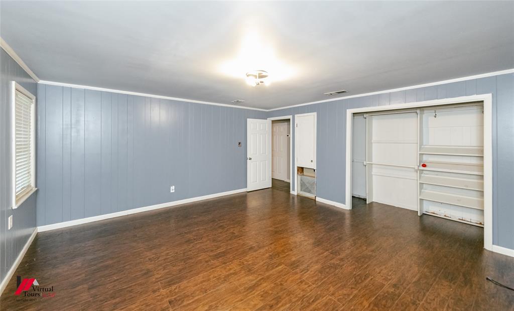 1177 Princeton Road Princeton, LA 71067 - Photo 14 of 34 an empty room with cabinet and wooden floor