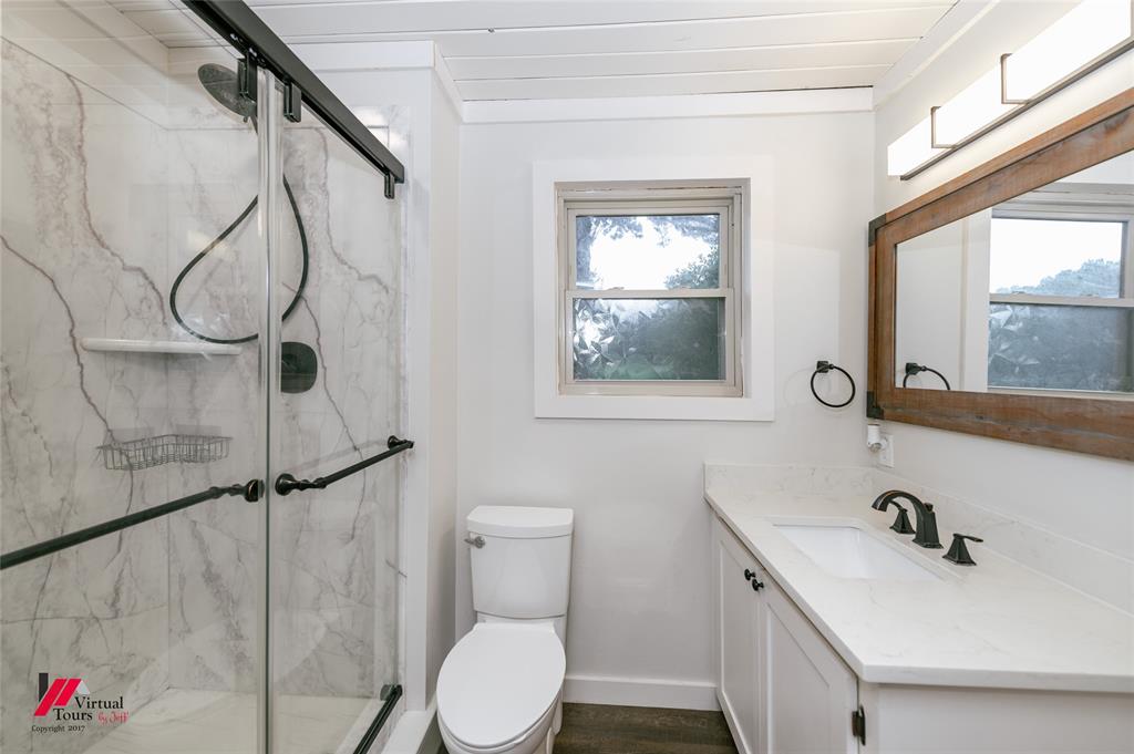 1177 Princeton Road Princeton, LA 71067 - Photo 21 of 34 a bathroom with a sink vanity mirror and toilet