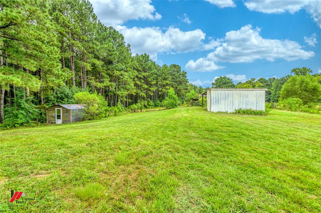 1177 Princeton Road Princeton, LA 71067 - Photo 28 of 34 a view of a garden with a building in the background