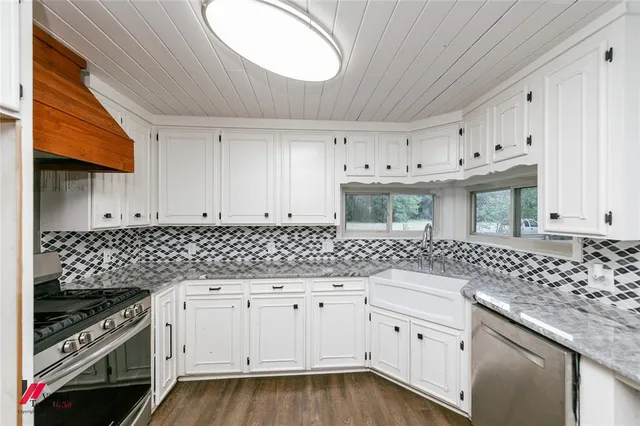 a kitchen with a sink stove and cabinets