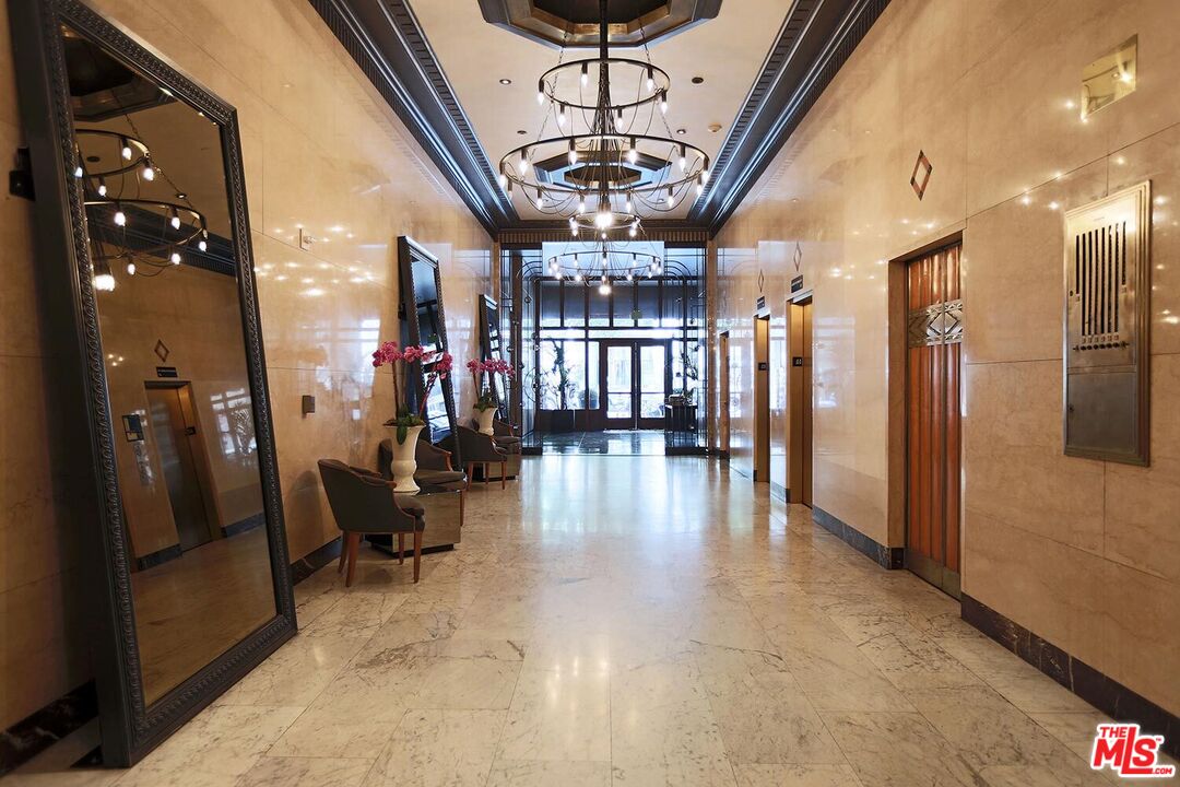 460 South Spring Street, Unit 201 Los Angeles, CA 90013 - Photo 23 of 27 a view of a hallway with couches and chandelier