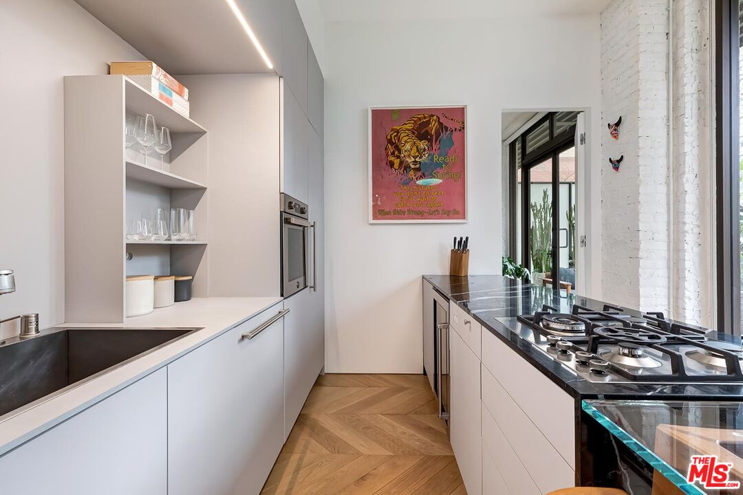460 South Spring Street, Unit 201 Los Angeles, CA 90013 - Photo 8 of 27 a kitchen with a sink and a stove top oven
