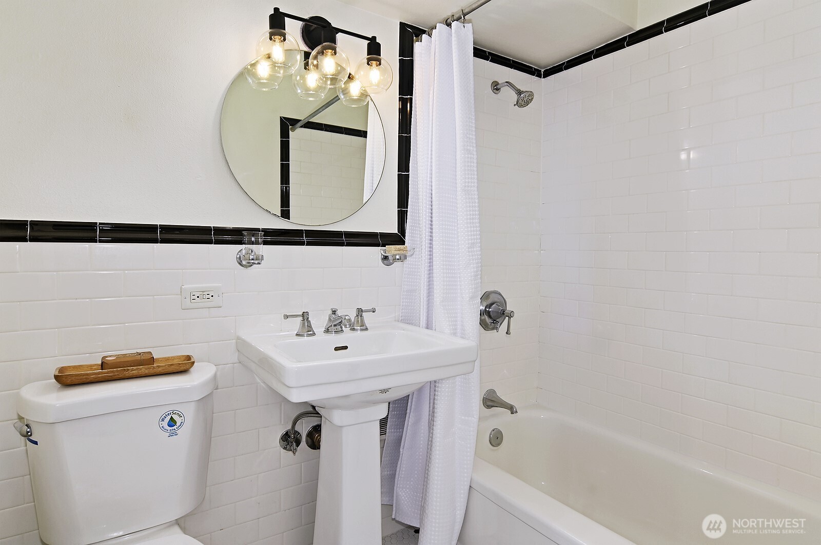 1105 Spring Street, Unit 709 Seattle, WA 98104 - Photo 17 of 30 a bathroom with a sink mirror toilet and bathtub