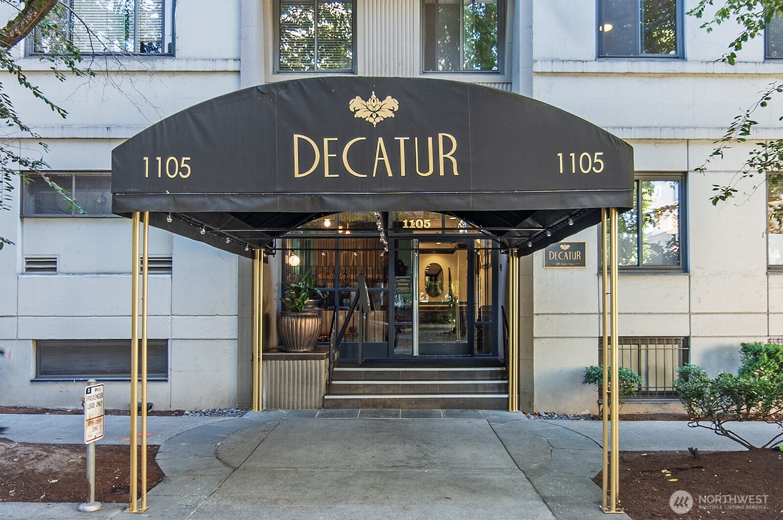 1105 Spring Street, Unit 709 Seattle, WA 98104 - Photo 2 of 30 a front view of a building with retail shops