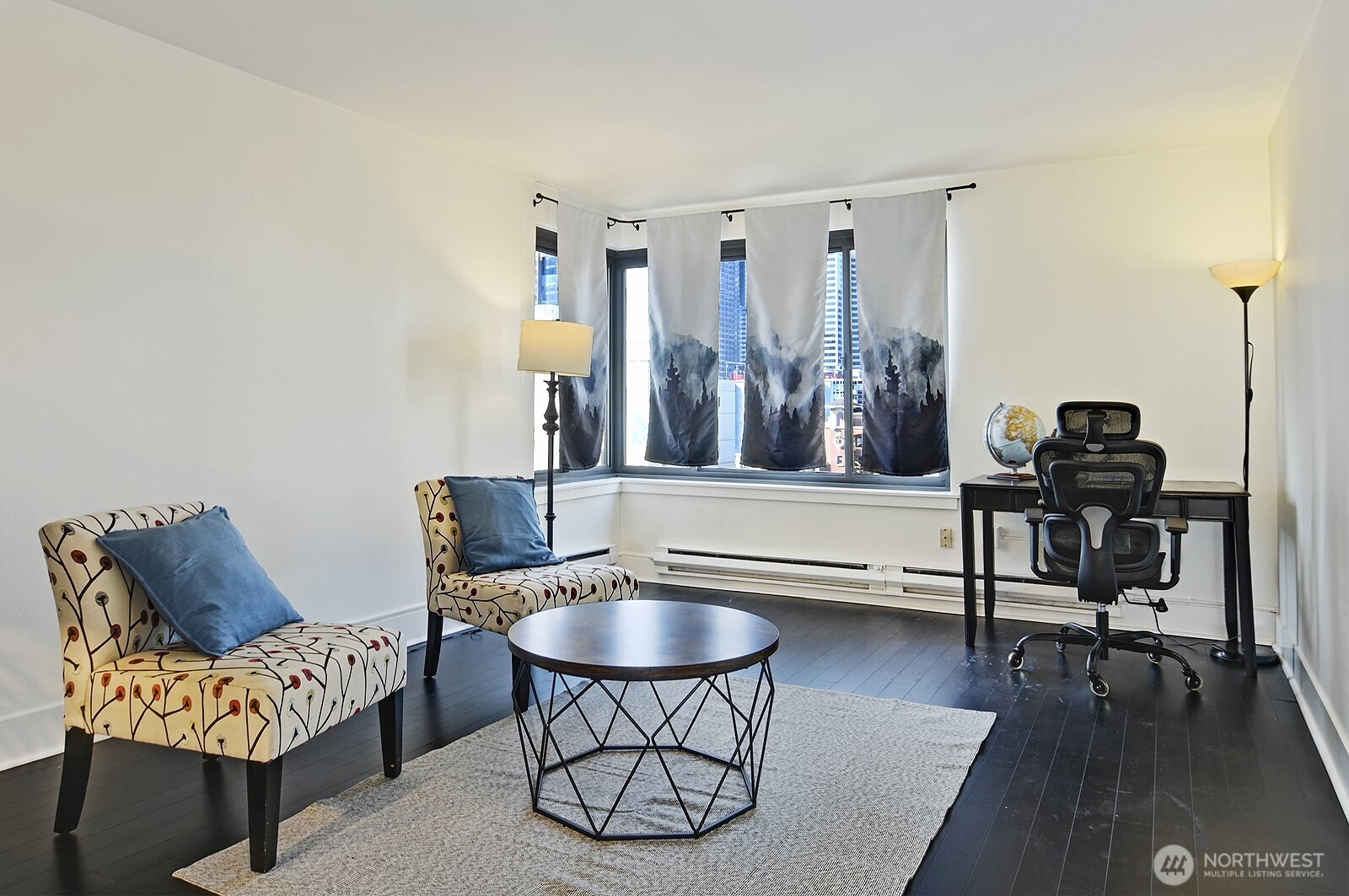 1105 Spring Street, Unit 709 Seattle, WA 98104 - Photo 4 of 30 a living room with furniture and a wooden floor