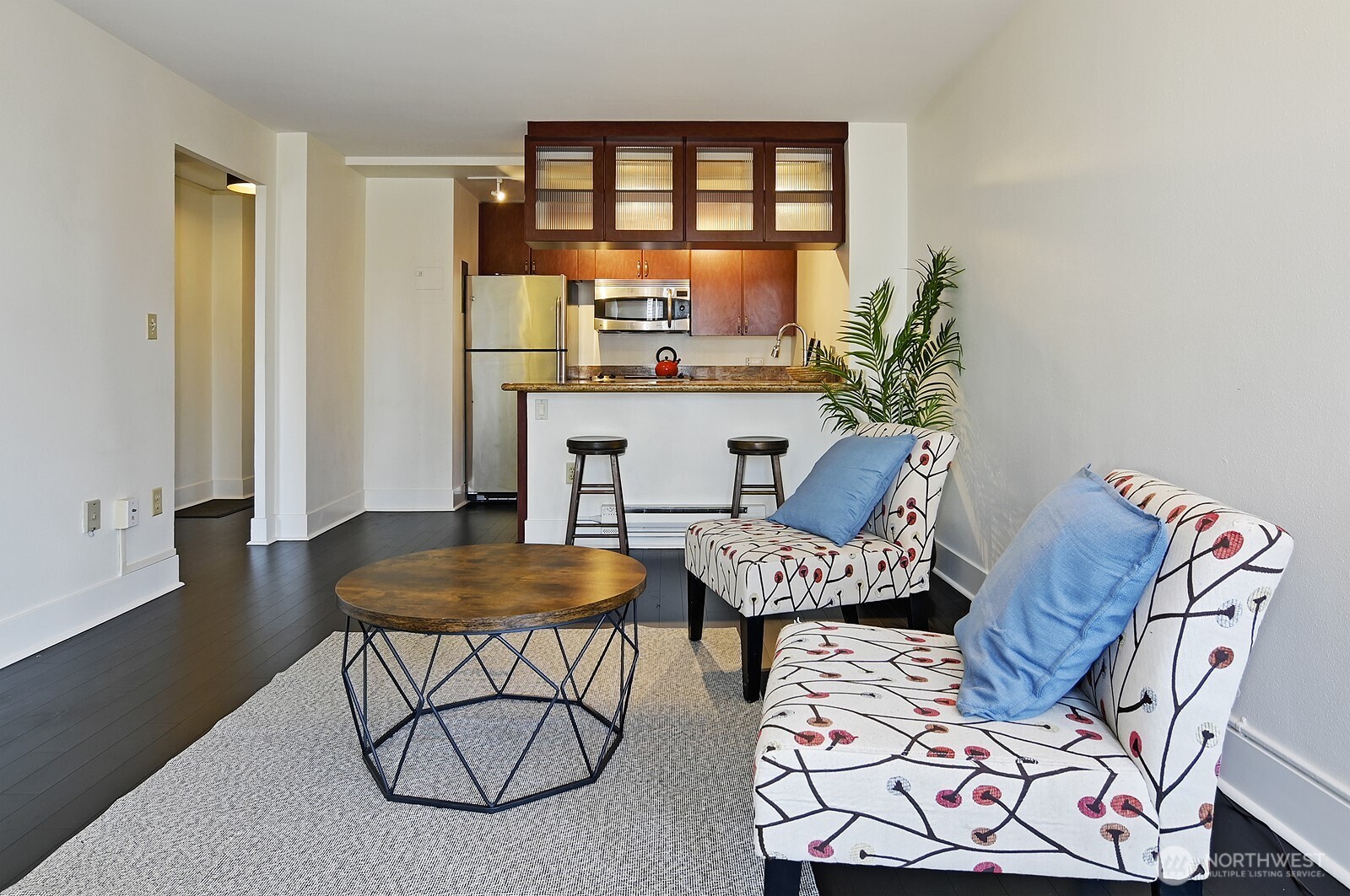 1105 Spring Street, Unit 709 Seattle, WA 98104 - Photo 6 of 30 a living room with furniture a rug and a window