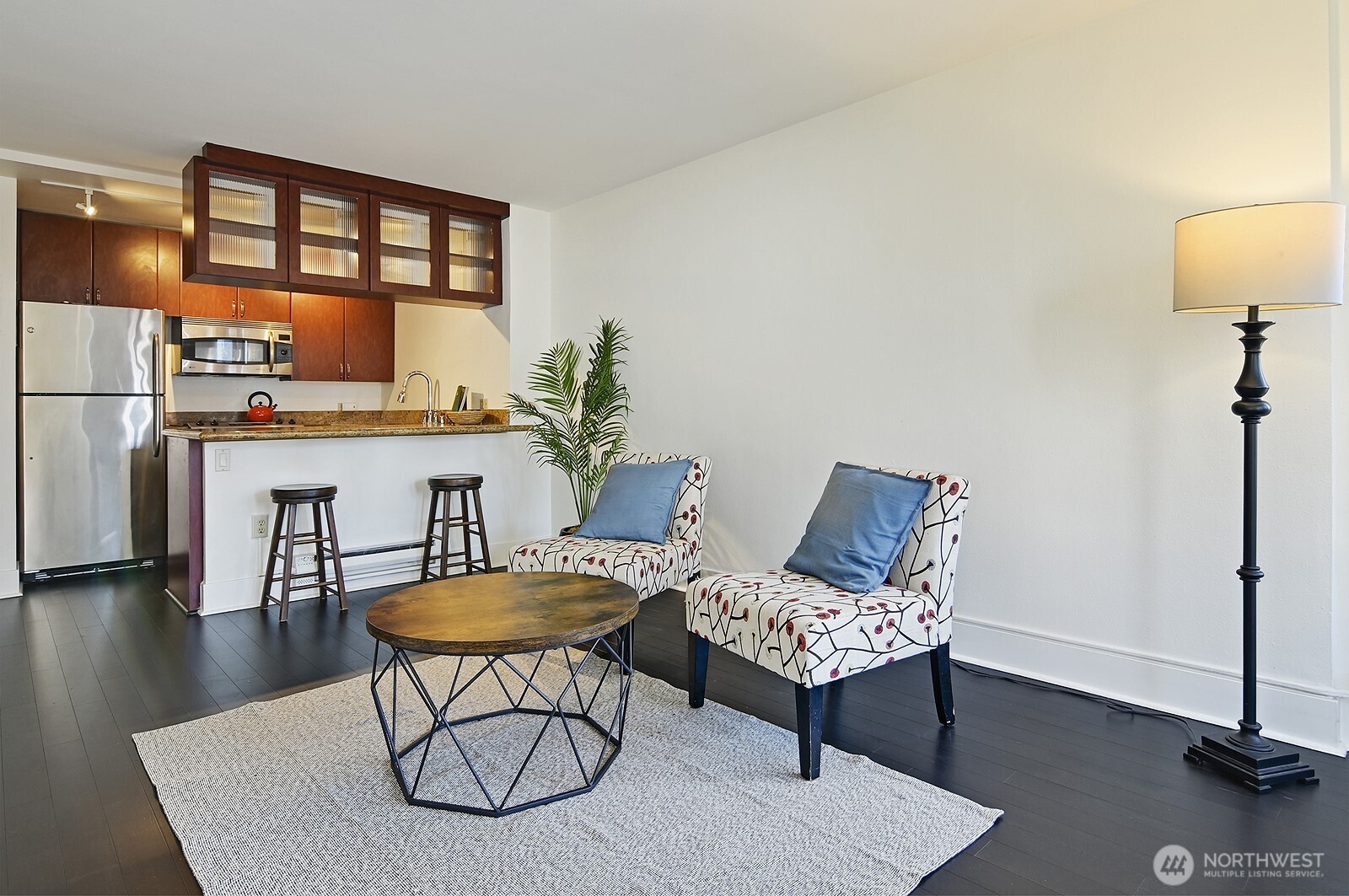 1105 Spring Street, Unit 709 Seattle, WA 98104 - Photo 7 of 30 a view of a livingroom with furniture and a table chairs