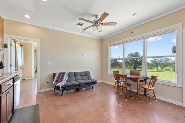 a dining room with furniture a rug and a large window