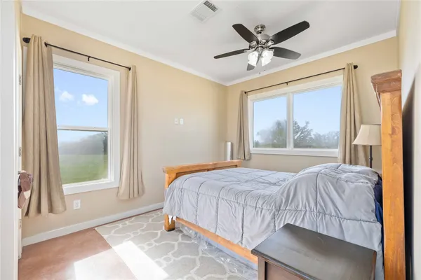a bedroom with a bed and window