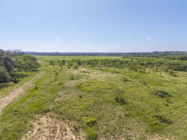 a view of a field with an ocean view