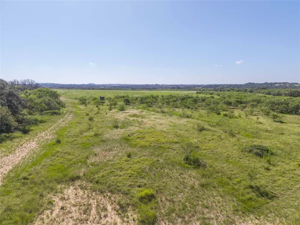 a view of a field with an ocean view