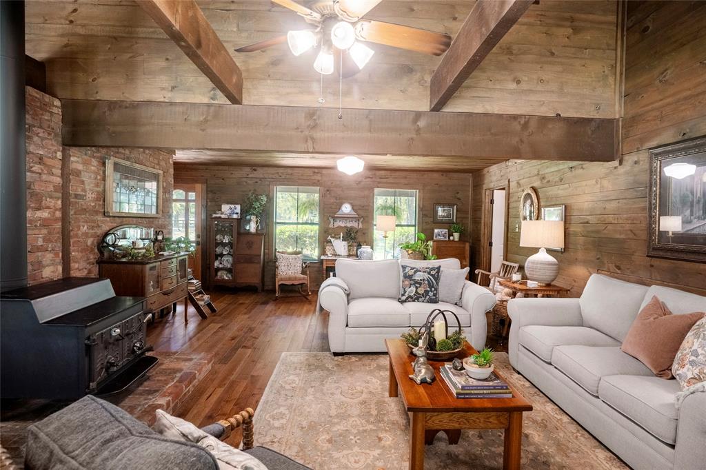 1516 Rancho Road Quinlan, TX 75474 - Photo 6 of 40 a living room with furniture a lamp wooden floor and a large window