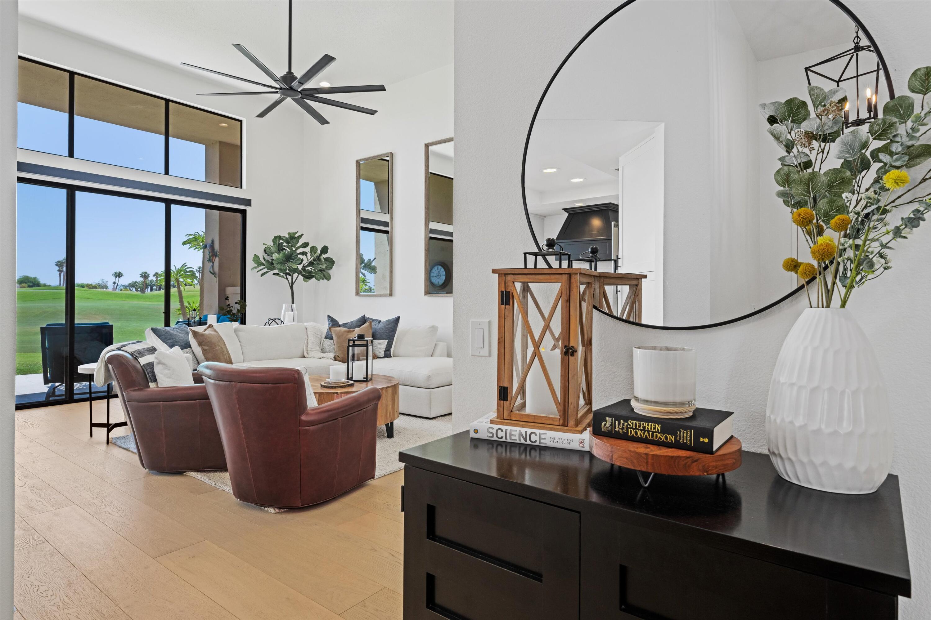 54754 Oak-Tree La Quinta, CA 92253 - Photo 13 of 33 a living room with furniture a flat screen tv and a large window