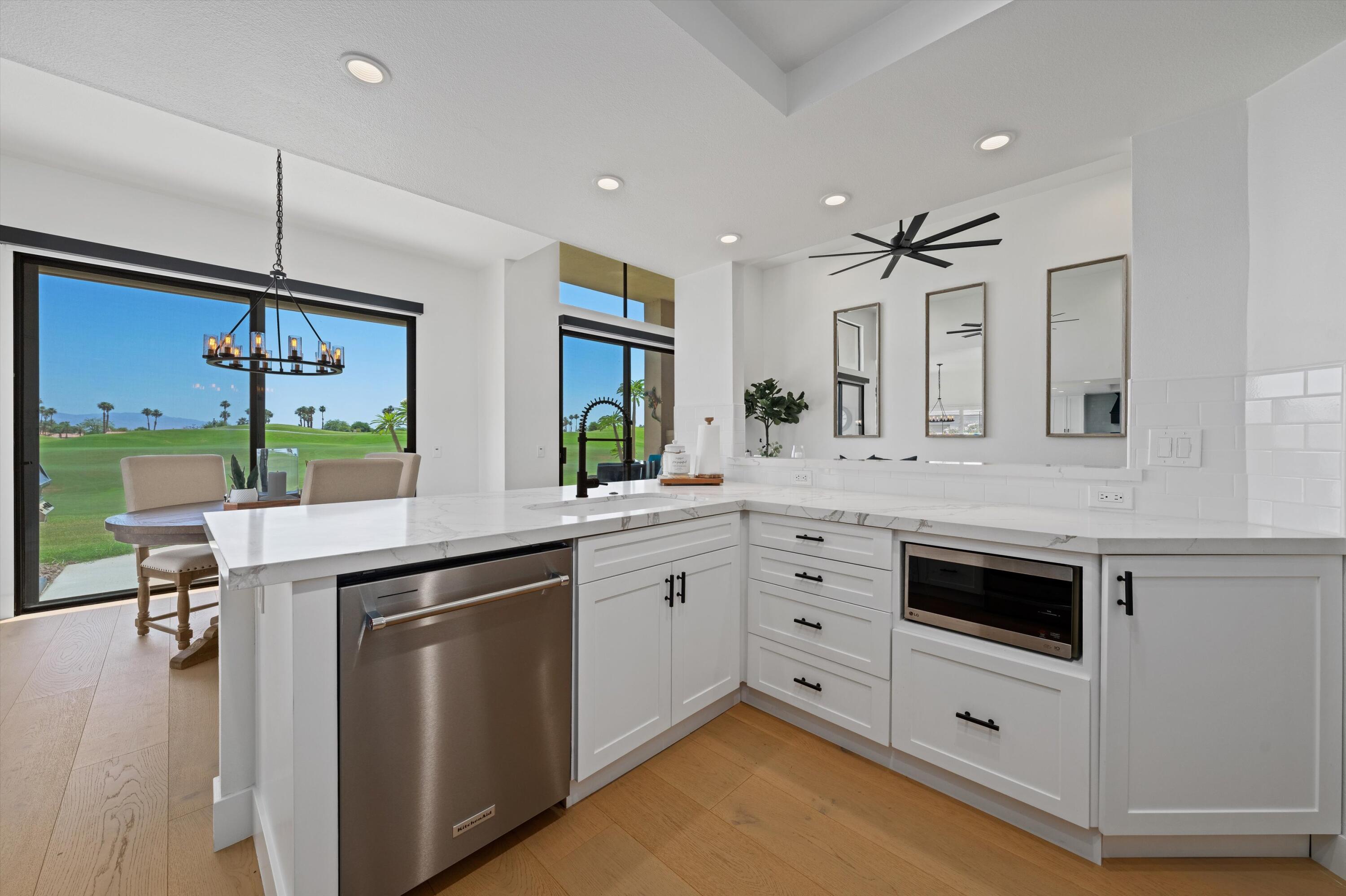54754 Oak-Tree La Quinta, CA 92253 - Photo 22 of 33 a kitchen with a sink stove and cabinets