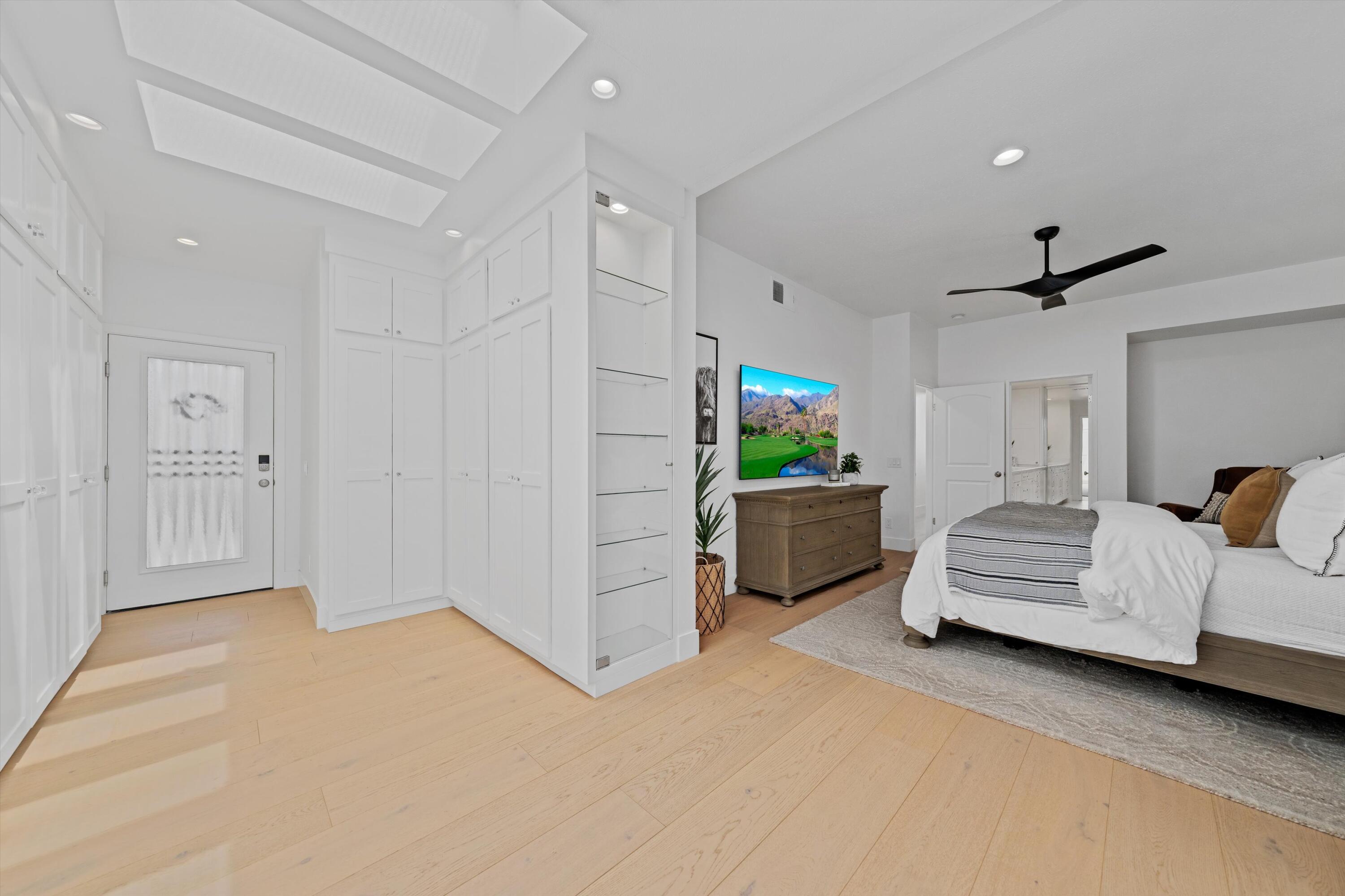 54754 Oak-Tree La Quinta, CA 92253 - Photo 28 of 33 a bedroom with furniture and a chandelier