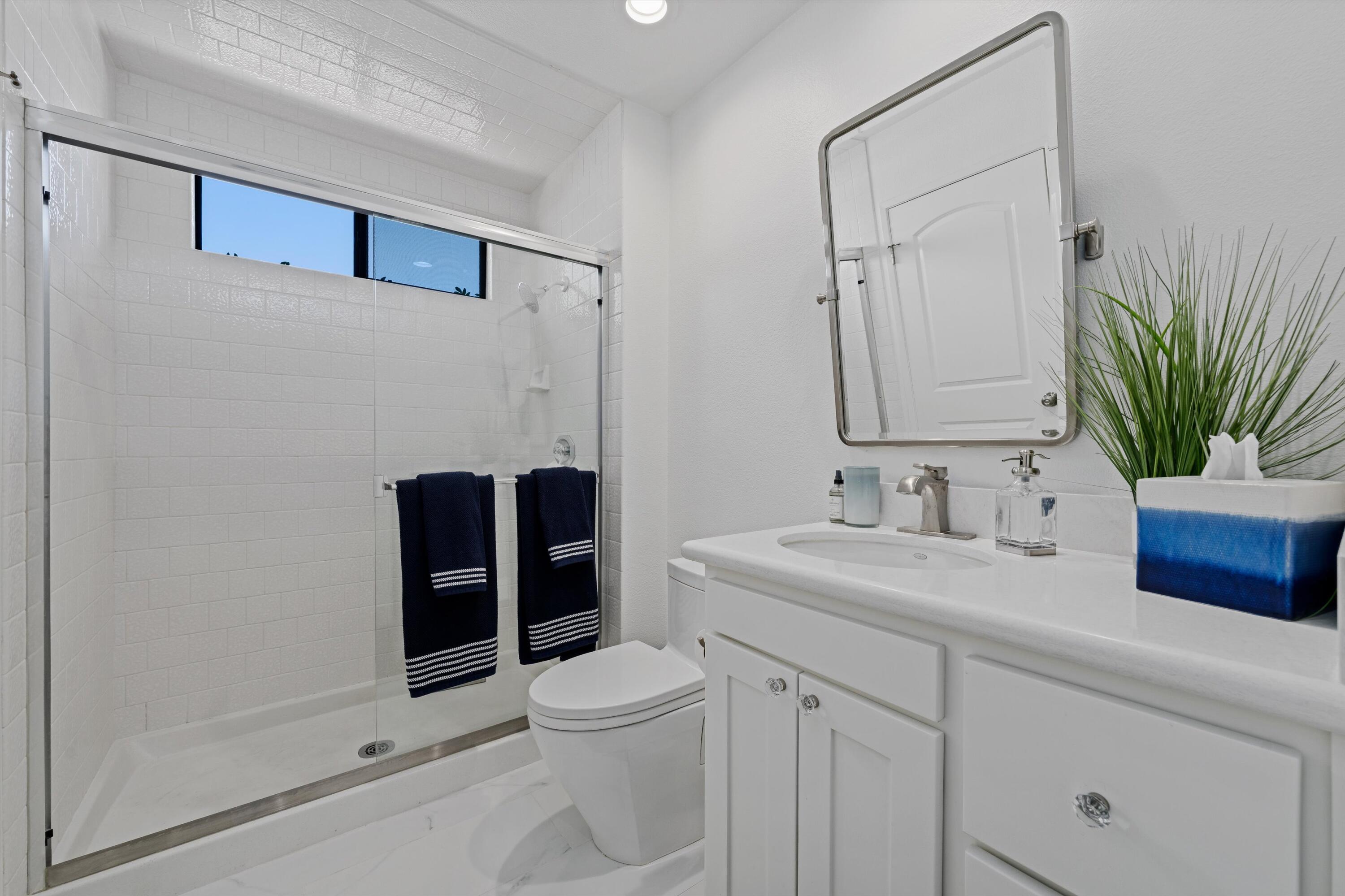 54754 Oak-Tree La Quinta, CA 92253 - Photo 32 of 33 a bathroom with a granite countertop sink a toilet and shower
