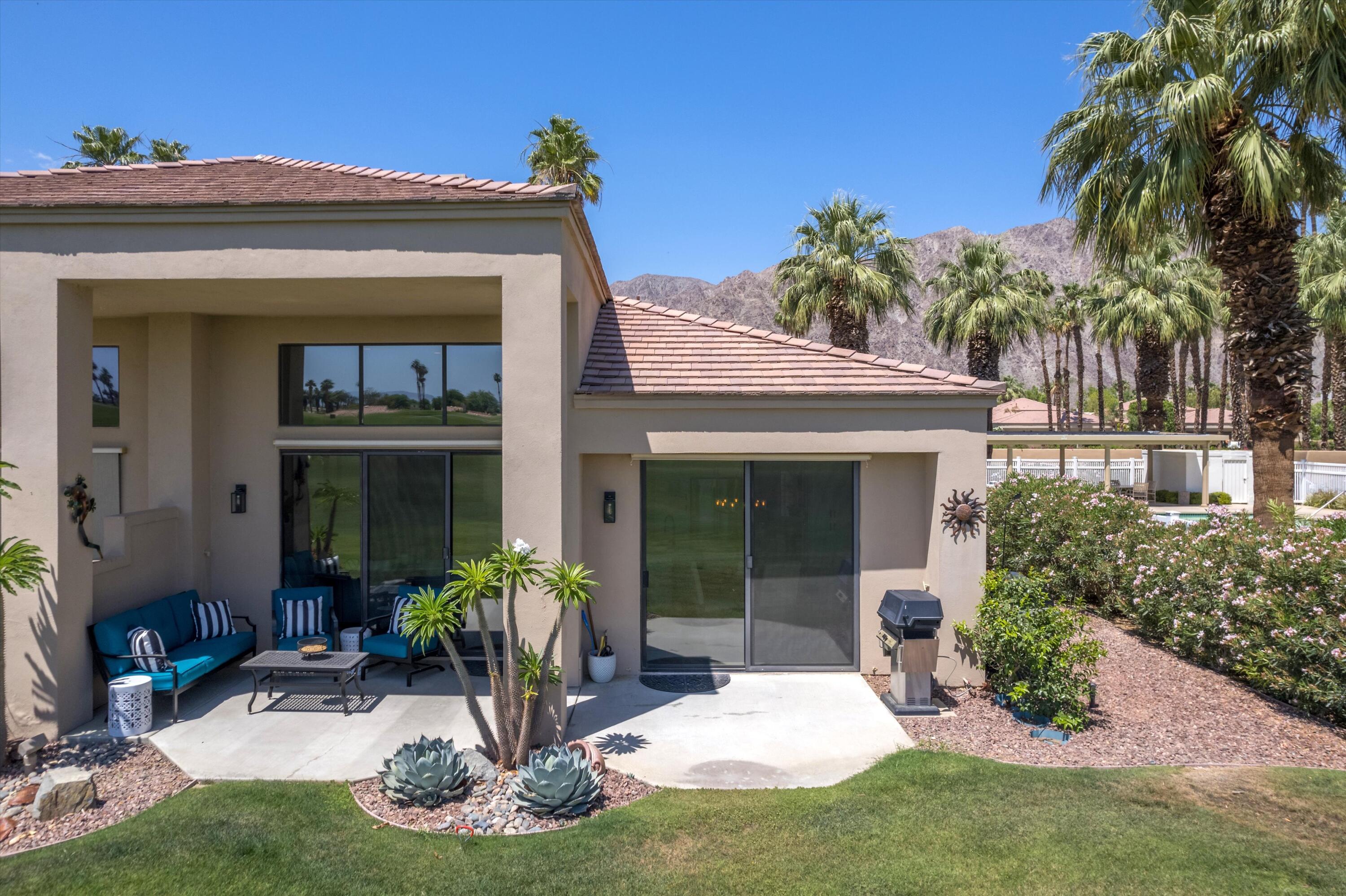 54754 Oak-Tree La Quinta, CA 92253 - Photo 7 of 33 front view of a house with a yard