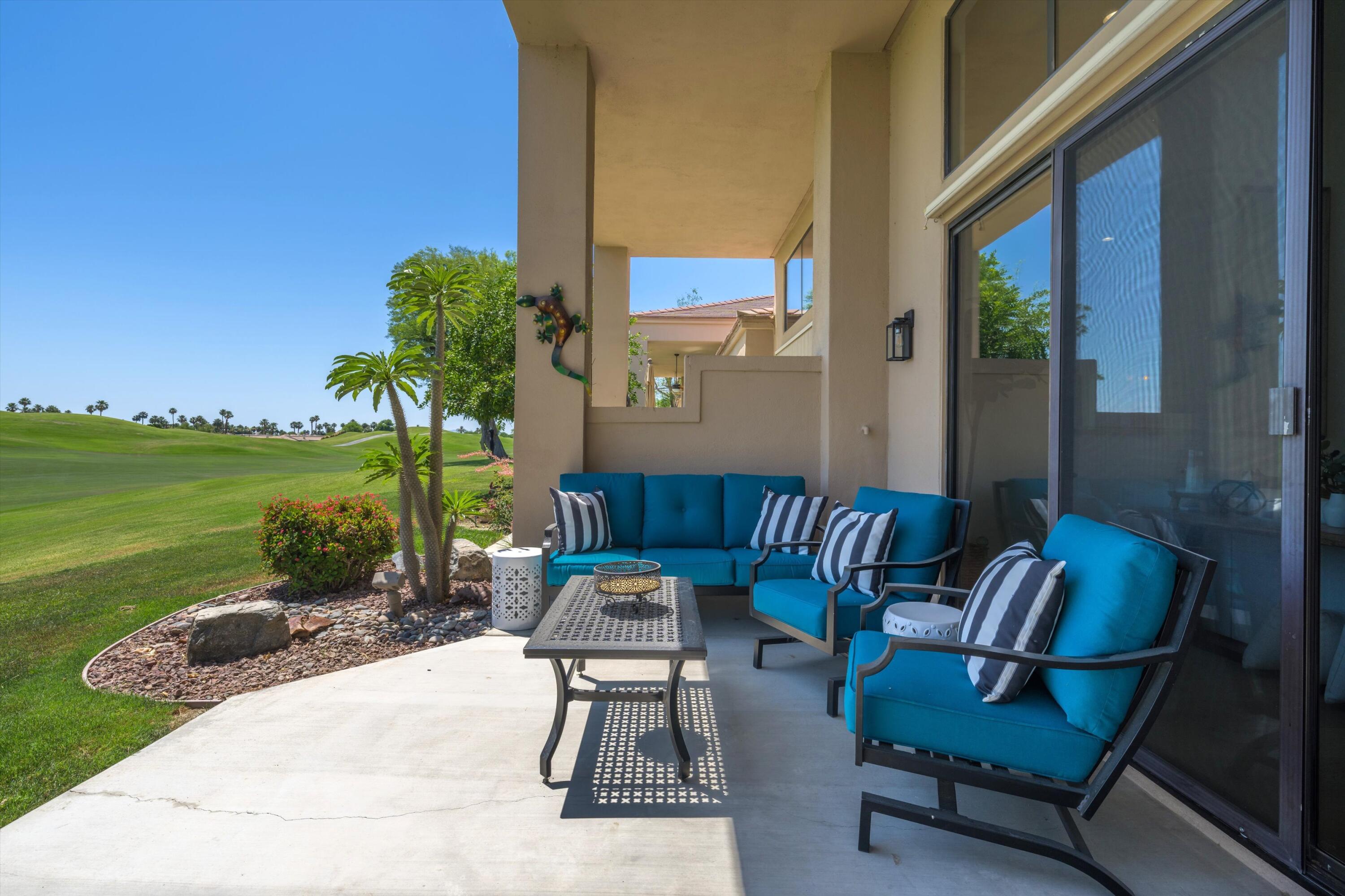 54754 Oak-Tree La Quinta, CA 92253 - Photo 9 of 33 a view of a patio with a table chairs and a garden