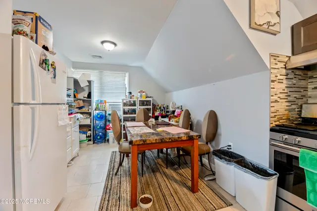 a view of a dining room with furniture a rug and wooden floor